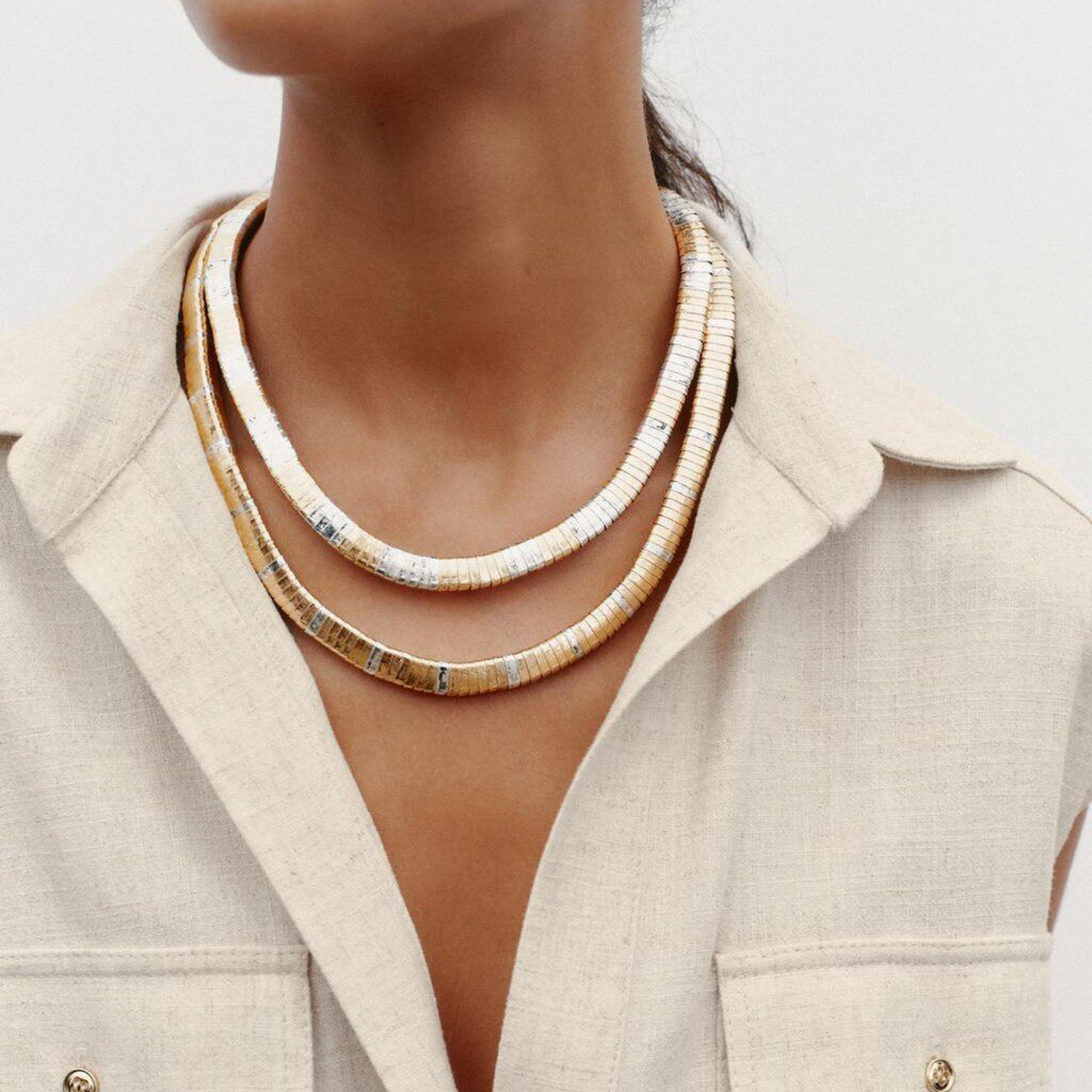 Mixed-tone layered necklace styled with an ivory shirt